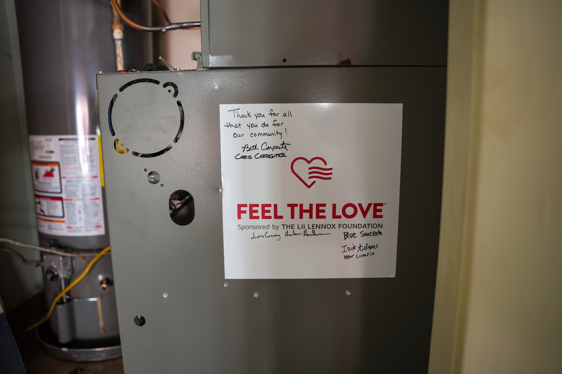 Signed Feel the Love placard on a new Lennox furnace