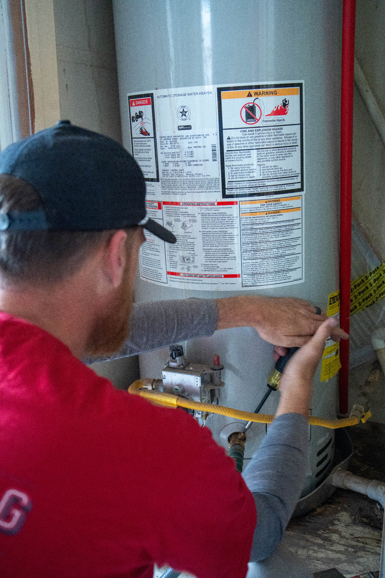 Armstrong plumber servicing water heater
